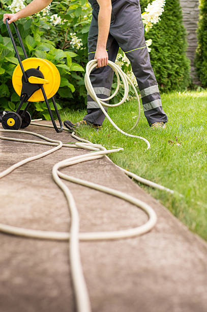 istock Gardener with a hose for watering 512302808