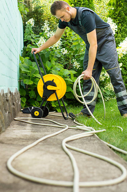 istock Gardener with a hose for watering 512302832