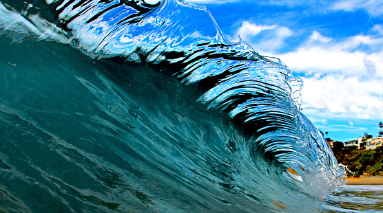 Perfect crystal clear wave in Laguna Beach, Southern California. You can see the clouds through the lip of the wave.