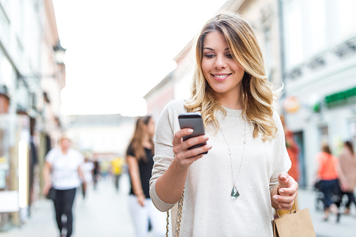 Attractive woman finding shopping deals online.