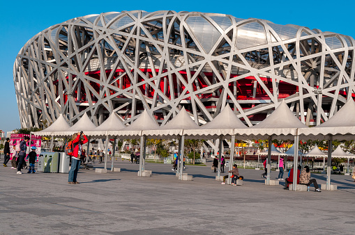 Beijing ,China - October 30, 2010: Beijing, China - October 30, 2010: Tourists in front of Beijing National Stadium Located on Beijing Olympic Green, the Beijing National Stadium was the home of the 2008 Beijing Olympics.