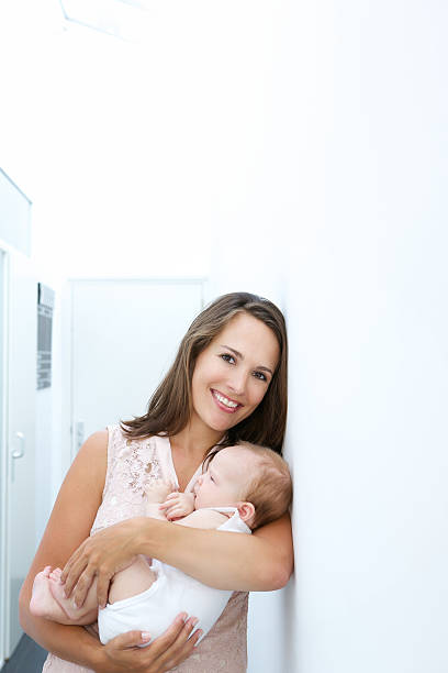 istock Beautiful mother smiling with small baby 512308599