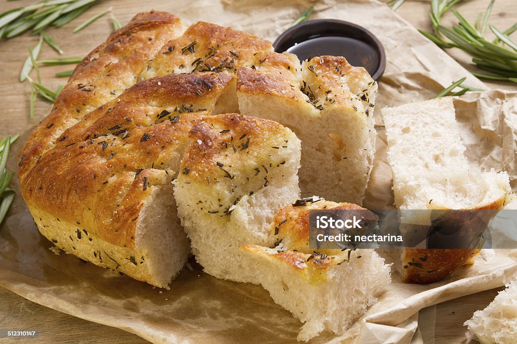 Fresh focaccia from the bakery Delicious fresh focaccia with rosemary, pepper and rock salt. Focaccia Bread Stock Photo