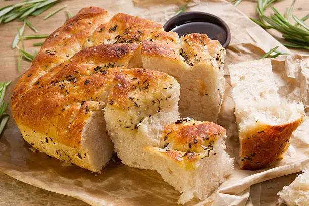 Delicious fresh focaccia with rosemary, pepper and rock salt.