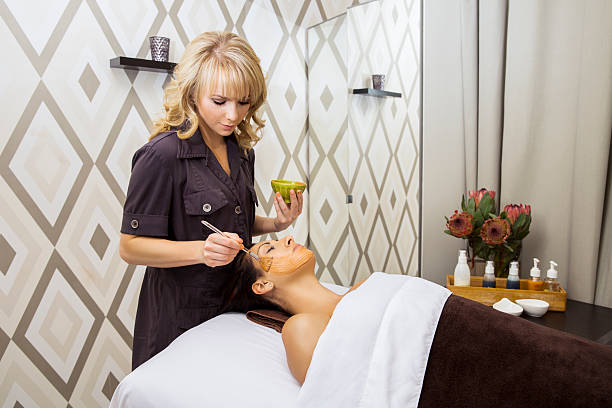 Spa series: beautiful young woman getting a facial mask Spa series: beautiful young woman in the spa getting a facial. You might also be interested in these: aesthetician photos stock pictures, royalty-free photos & images