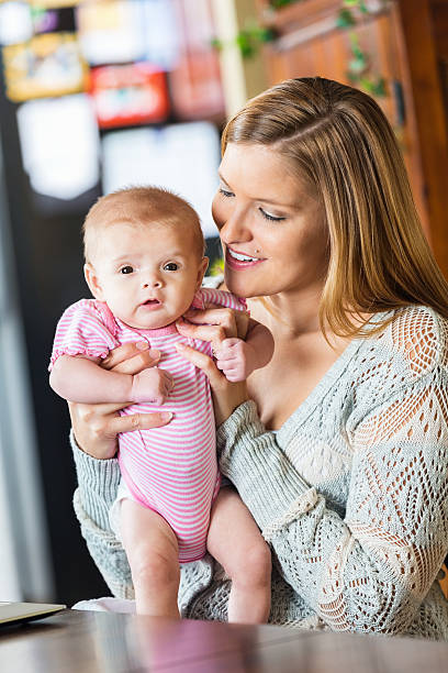 istock Proud mother holding tiny baby daughter at home 512320687