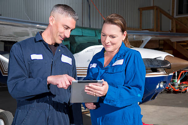 istock Airport: two airplain mechanics, male and female, verifying the paperwork 512322065