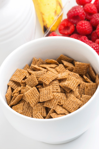Morning whole wheat cereal and fruit on white background