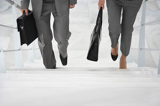 istock Two Businesspeople Walking Up Stairs 512326243