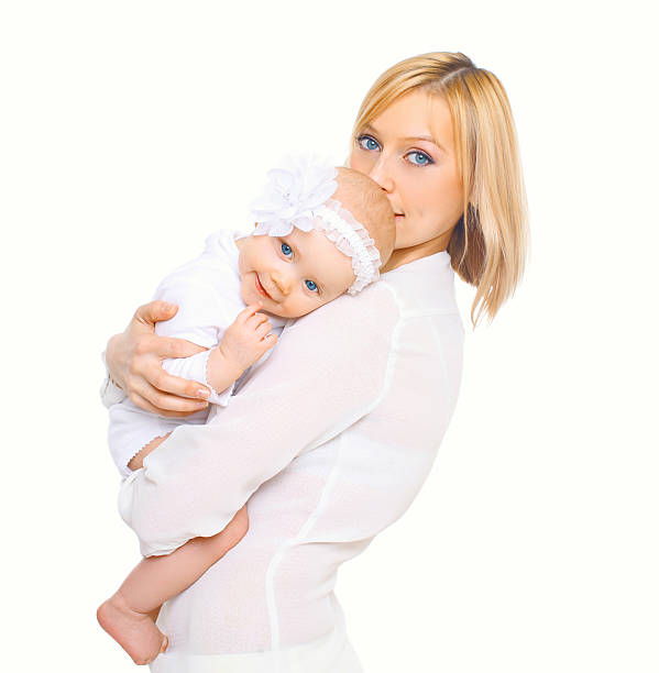 young hispanic latina mother and baby in her arms while walking outdoors
