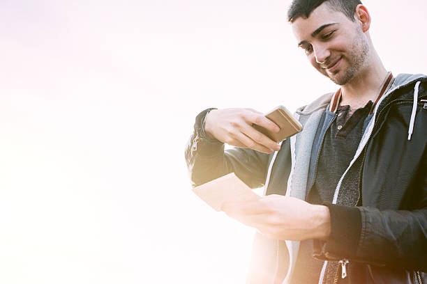 istock Adult Man Depositing Check with Smart Phone 512328254
