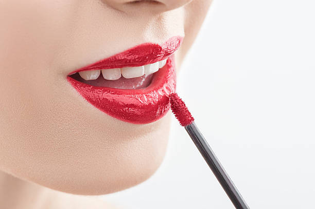 istock Pretty young woman is doing make-up 512331240