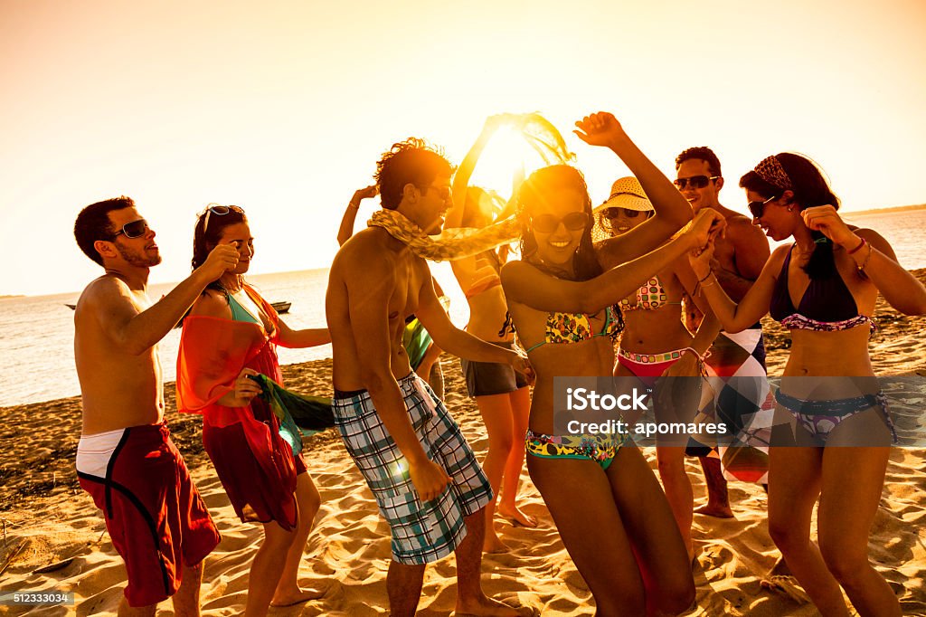 Spring break backlit group of young people dancing on beach - Royalty-free Plaj Stok görsel