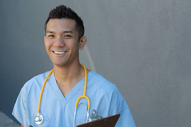 Handsome Filipino healthcare professional smiling Filipino healthcare professional. operating budget stock pictures, royalty-free photos & images