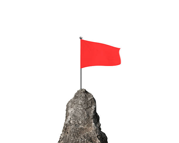 istock Red wavy flag on top of rocky mountain peak 512333720