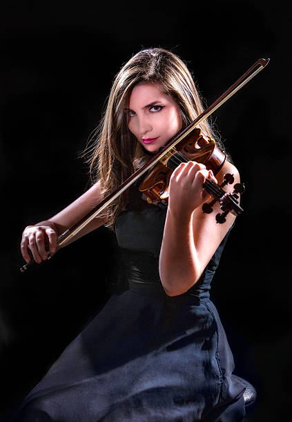 istock Self confident young woman and violinist player during presentation 512334334