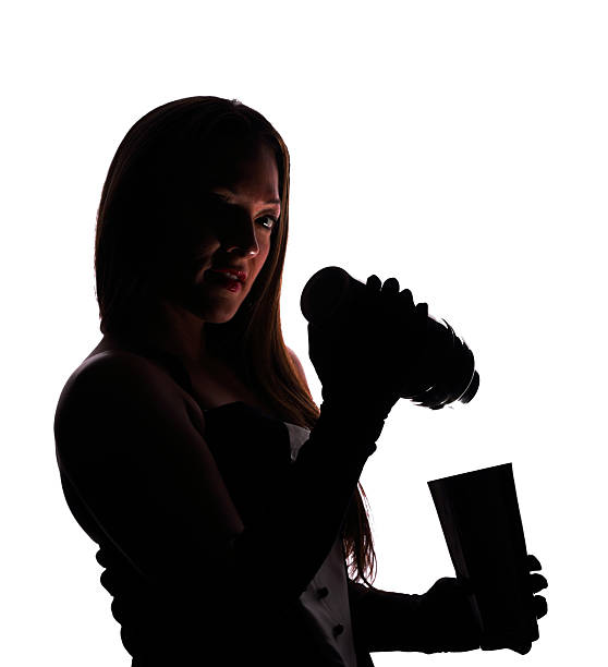 istock Silhouette of a female bartender with a cocktail shaker 512336054