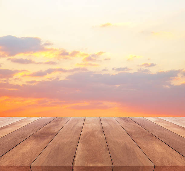 istock wood plank and sunset or sunrise with beautiful sky background 512336350