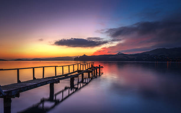 istock Colourful Orange And Red Sunrise At Otago Harbour With Pier 512337444