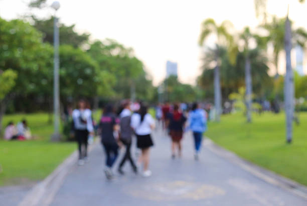 istock blurred people lifestyle at public park in the evening 512337644