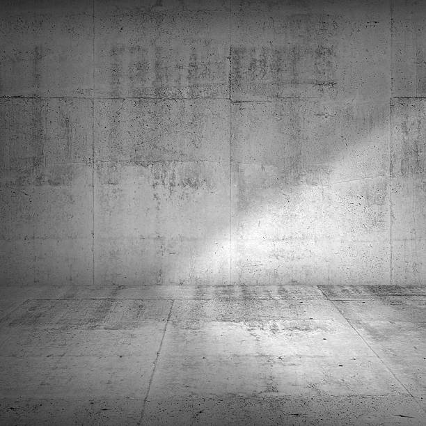 istock Concrete wall and floor with strong side illumination 512338392