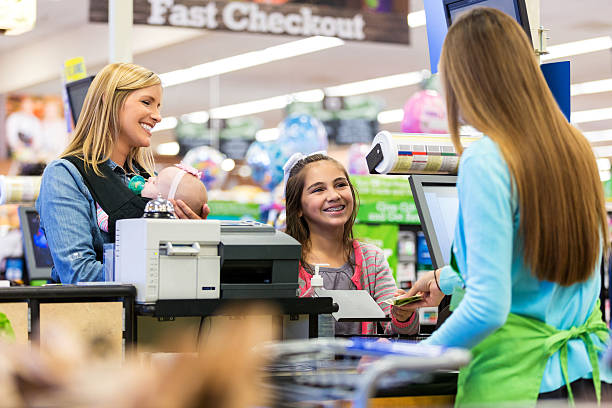 istock Elementary age customer using cash to pay for supermarket purchases 512339110