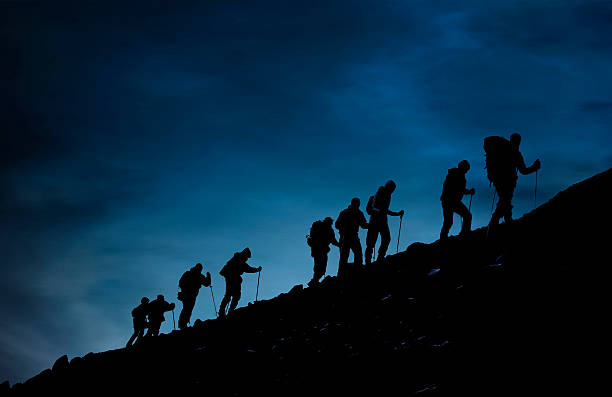 istock Silhouette of Hikers At Dusk 512340020