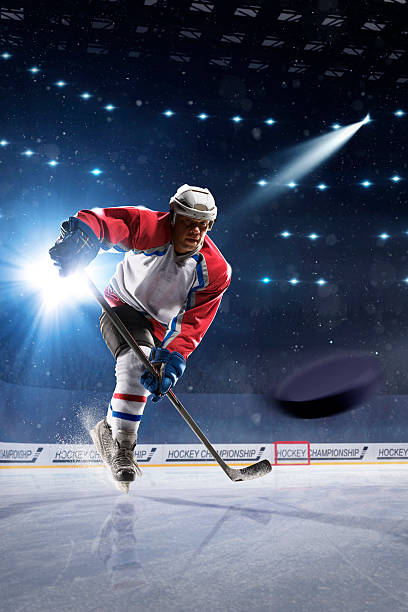 istock Ice hockey player on the ice arena 512340304
