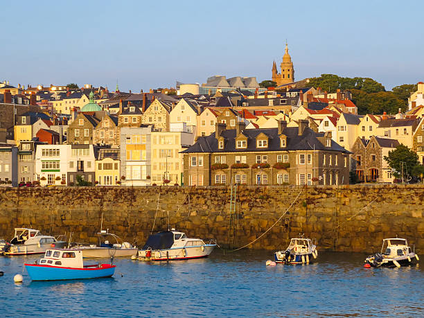 View of harbor Saint Peter Port and Castle Cornet at sunrise. Bailiwick of Guernsey, Channel Islands