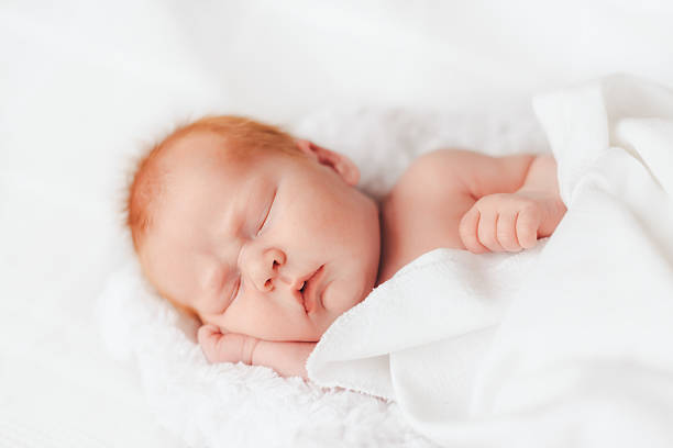 istock sleeping newborn baby in a wrap 512341636