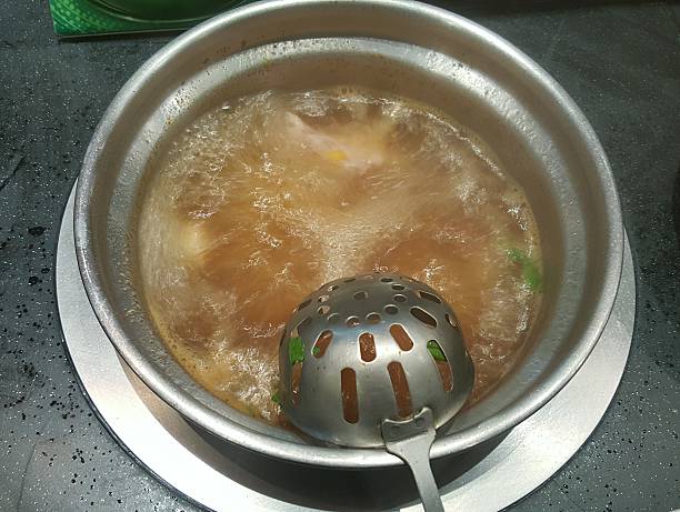 istock boil soup in the hot stainless pot 512343390