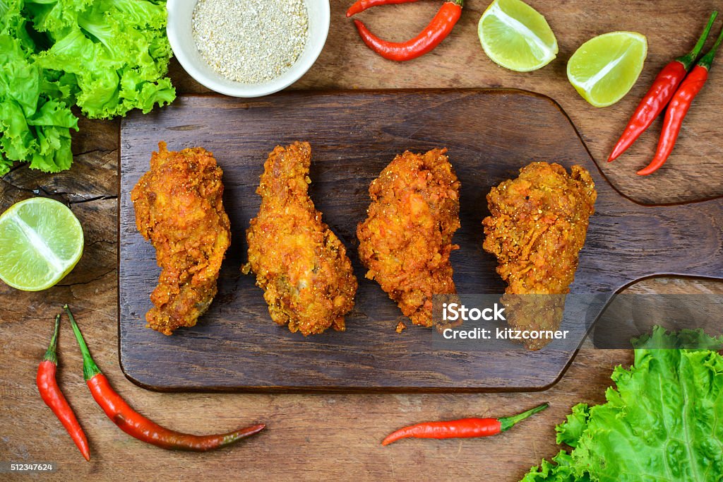 Fried spicy Chicken with roasted rice powder Fried spicy Chicken with roasted rice powder on wooden table Chicken Meat Stock Photo