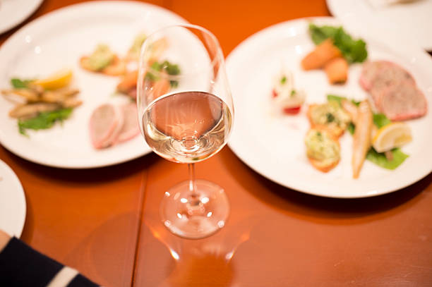 Champagne and cuisine that are arranged on desk