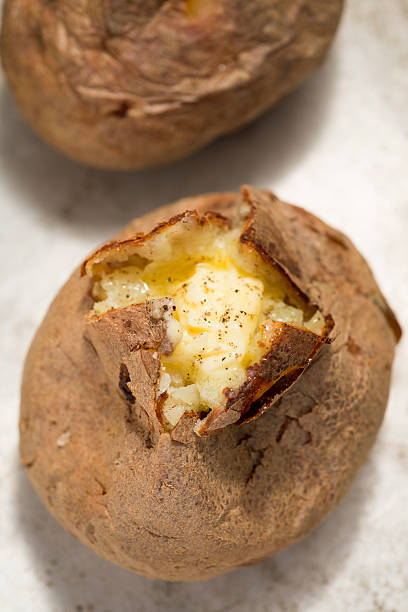 istock Jacket potato with butter and black pepper 512348328