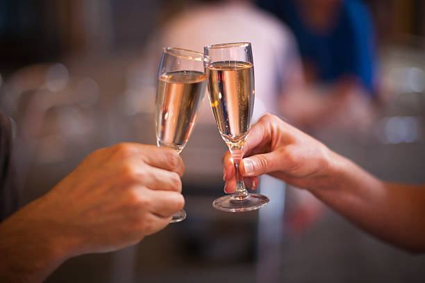 istock Celebration: cheering with a glass of champagne 512348458
