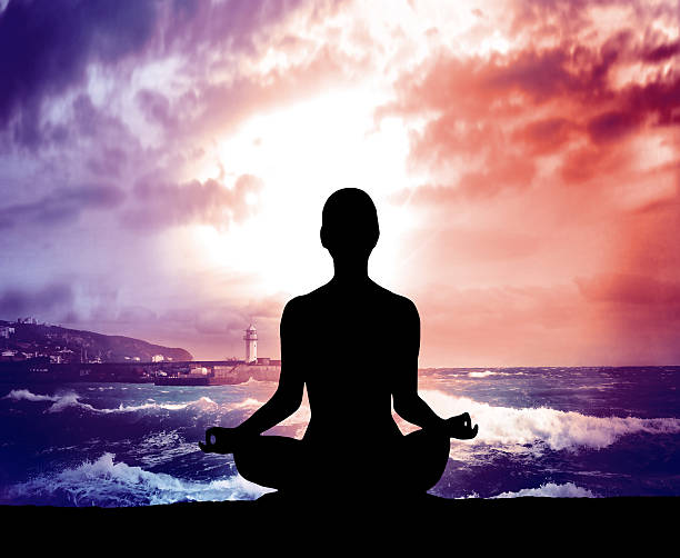 istock Silhouette young woman practicing yoga on the beach. 512349012