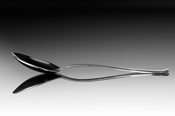 Silver spoon in air isolated on white