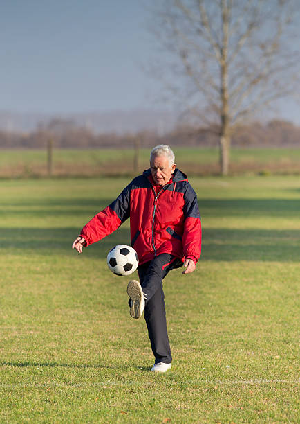 istock Old man playing football 512352288