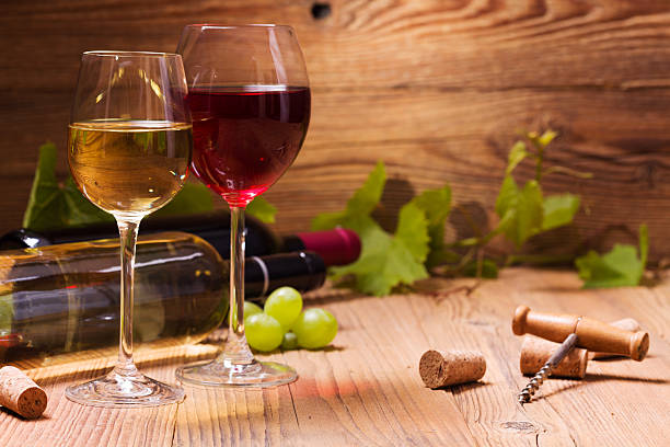 istock Glasses of red and white wine, served with grapes 512352680