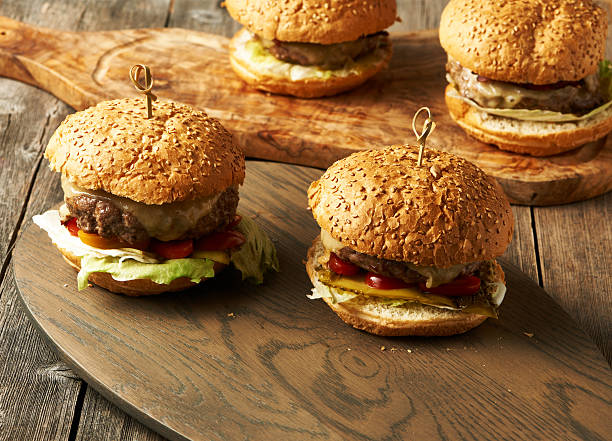 istock Home made cheeseburgers on wooden table 512353002