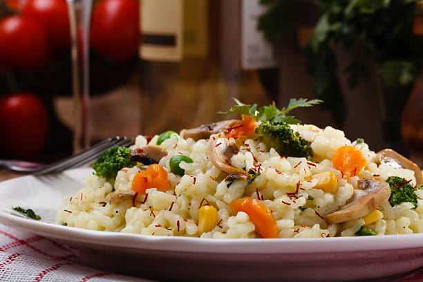 istock Classic Risotto with mushrooms and vegetables served on a white 512353932