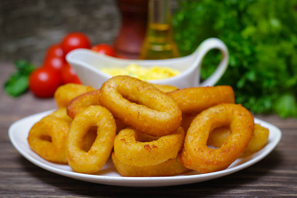 istock deep fried calamari with sauce and salad 512354738