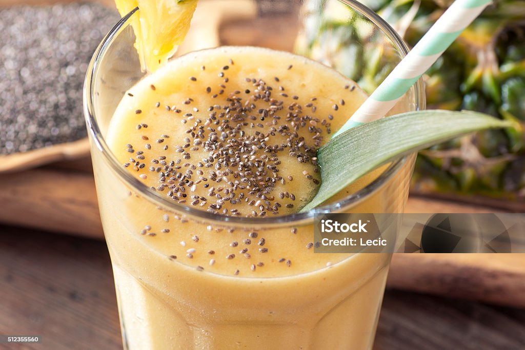 pineapple smoothie with chia seed pineapple smoothie with chia seed on wooden table. Alcohol - Drink Stock Photo