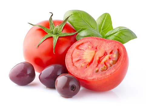 Tomatoes with basil and olives in closeup