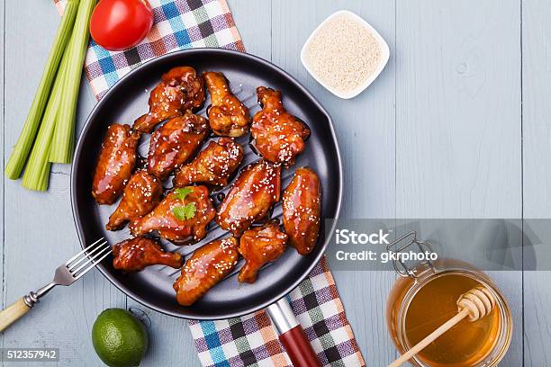 Baked Chicken Wings In Honey Sauce Sprinkled With Sesame Seeds Stock Photo - Download Image Now