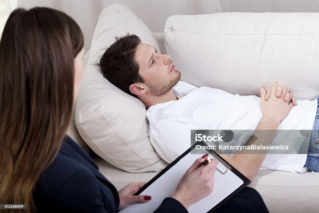 Therapist working with patient on hypnosis Young therapist working with patient on hypnosis Adult Stock Photo