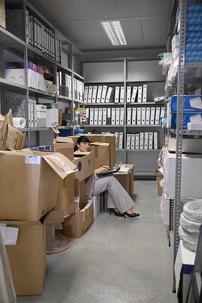 istock Woman Using Laptop In Office Storage Room 512358369
