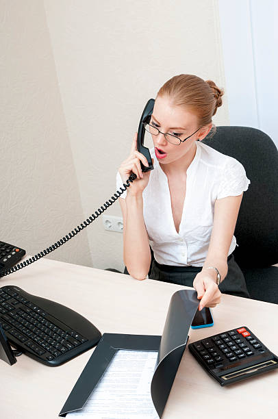 istock Busy office girl talking on phone. 512358409