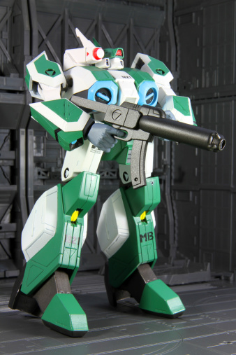 Vancouver, Canada - July 6, 2014: A battloid mode veritech fighter from the MOSPEADA animated television series against a technological background. The model is manufactured and distributed in North America by Robotech.com