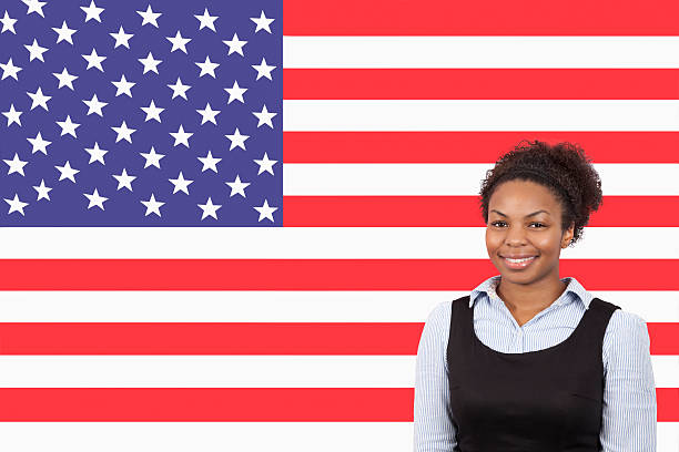 Business person in front of flag